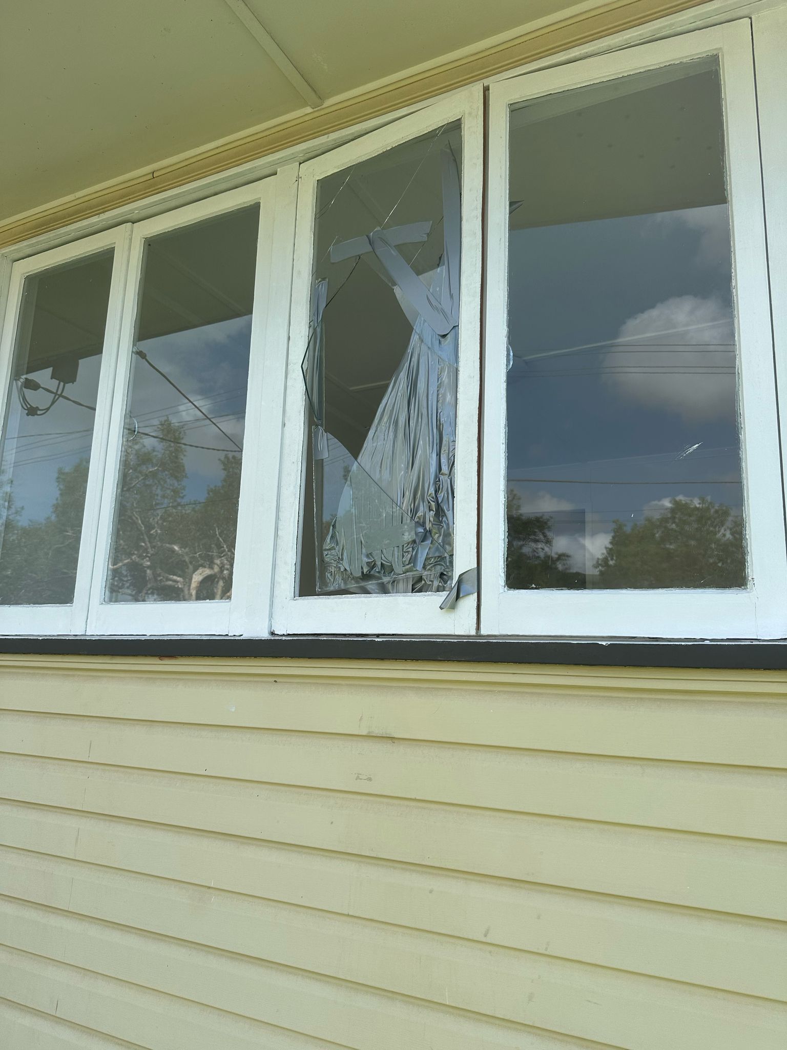 Before: broken window glass needing make-safe